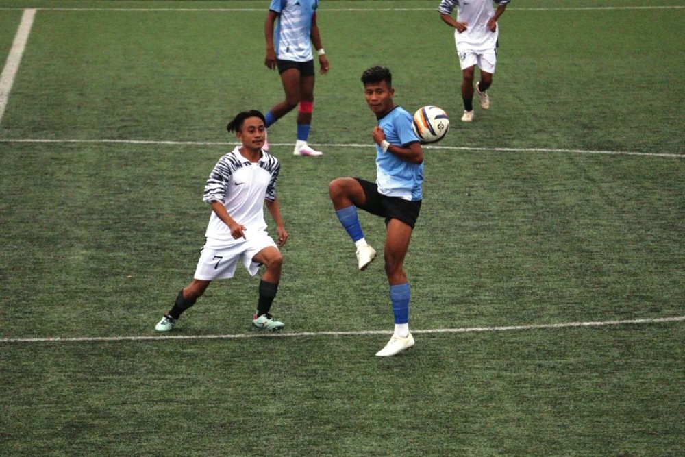 Legit FC (white jersey) and Khiamniungan Sports Council playing the first match of day three of 33rd Loyem Memorial Trophy in Tuensang town. (Morung photo)